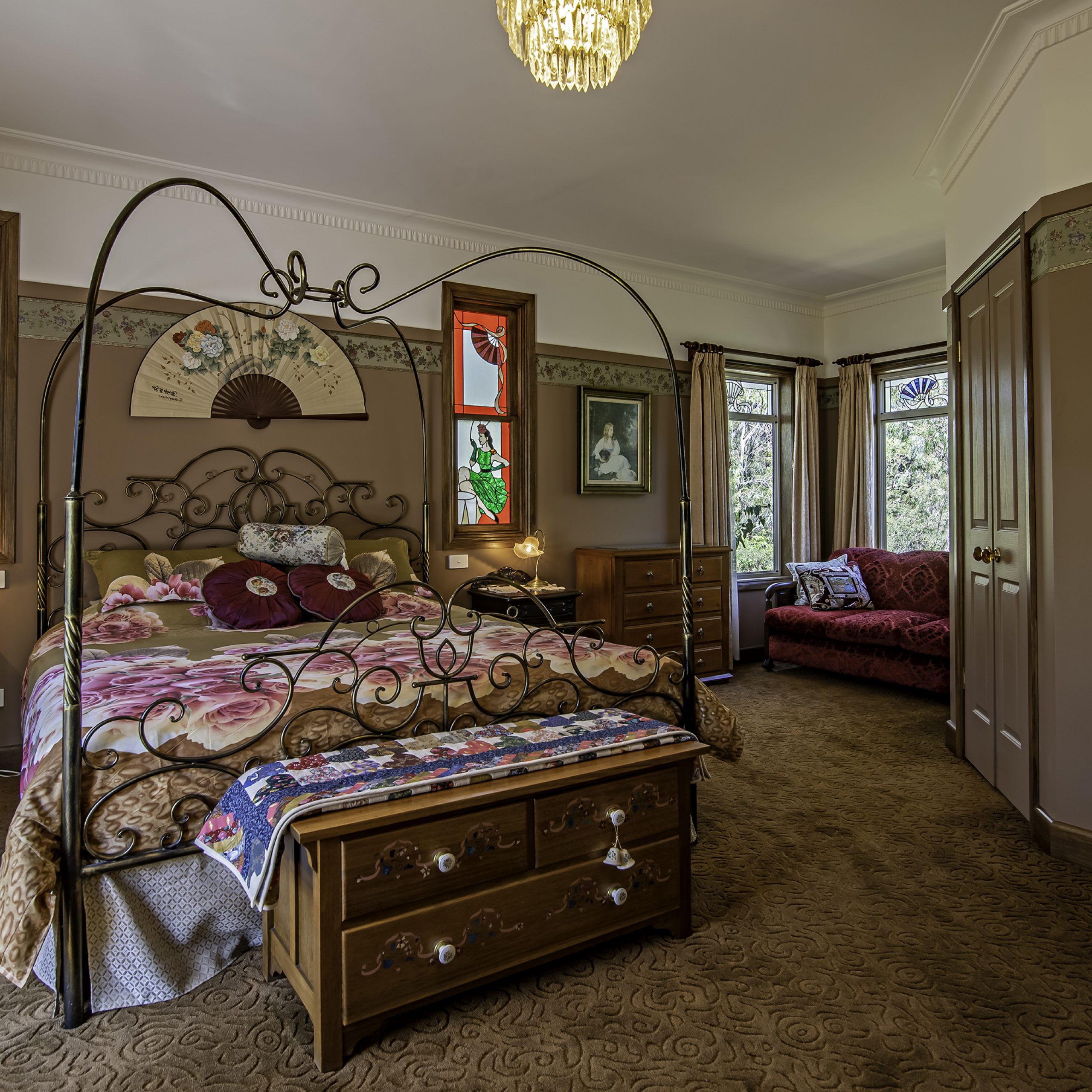 Interior of cottage bedroom with pattern bedspread.